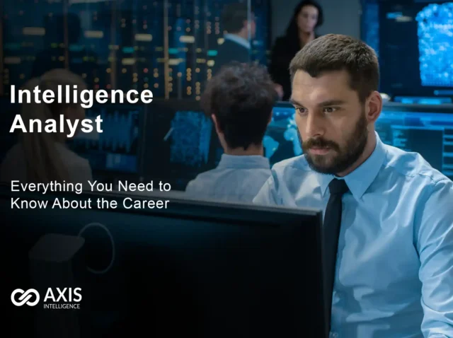 Intelligence analyst reviewing data on multiple computer screens in secure facility
