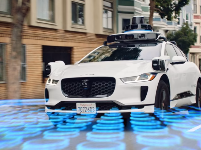 waymo-statistics Waymo statistics 2026 infographic showing 500000 weekly rides 220 million autonomous miles and 6 billion valuation Waymo robotaxi statistics 2026 chart comparing rides fleet size safety crash rates and revenue data across six US cities waymo safety statistics 2026 infographic